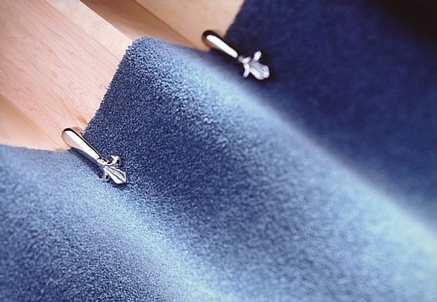 silver Victorian stair clips with a blue rug|
