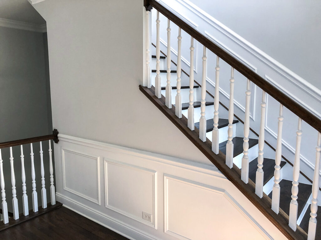 stairs with dark wood finish and white spindles