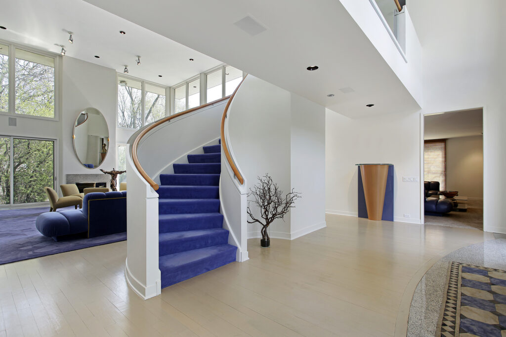 Foyer in modern home with purple carpeted stairs