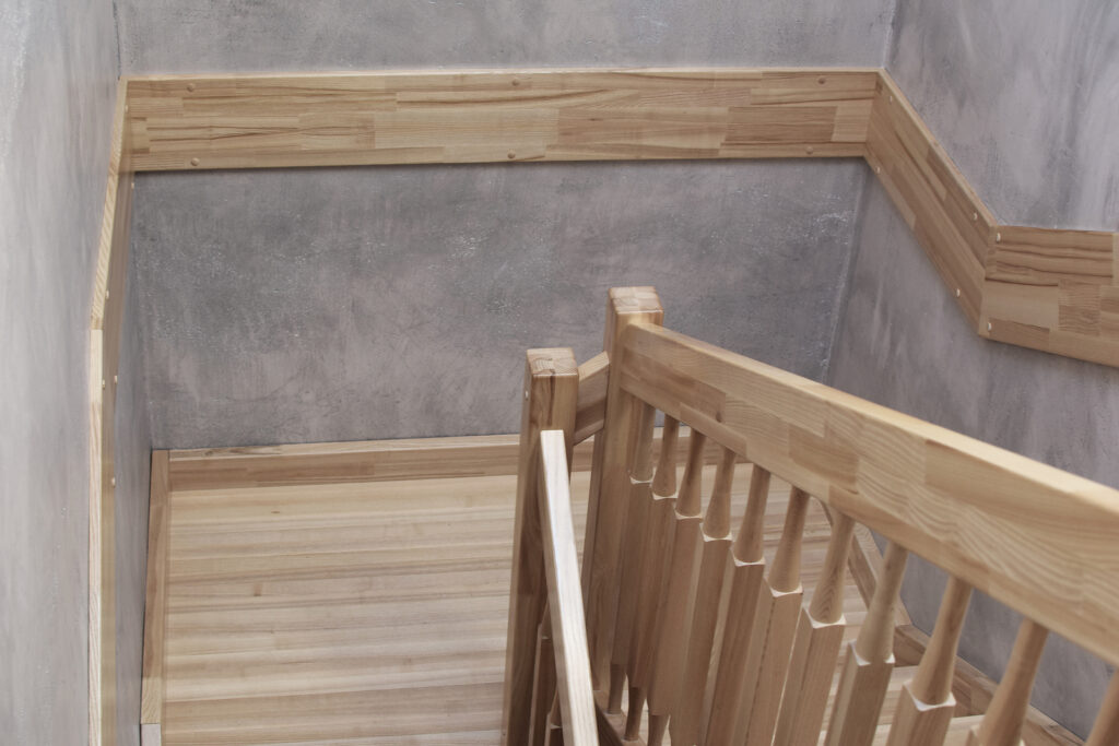 Natural ash tree wooden stairs with railings.